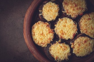 Portabello mushrooms stuffed with suluguni cheese in a clay pan, ketsi, Georgian cuisine, hot