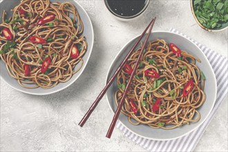 Udon noodles, with shimeji mushrooms, vegetables, in sauce, with sesame seeds, green onions, Asian