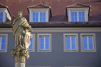 Patron saint Minerva with hand mirror and city coat of arms as shield and gable with dormers and