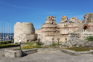 Sunny view of old ruins with blue sky and sea view, symbolising historical significance and