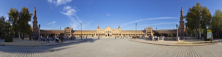 Spacious piazza with impressive architecture and towers under a bright blue sky, Seville