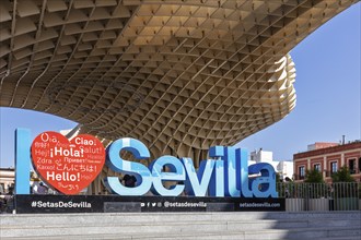 Welcome sign in various languages in front of the imposing architecture of the Metropol Parasol,