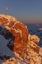 Mountain peak with summit cross in the evening light, sunset, winter, Zugspitze, Zugspitze summit,