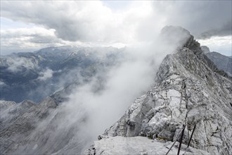 Clouds around a narrow rocky ridge, Watzmann crossing to Watzmann Mittelspitze, view of mountain