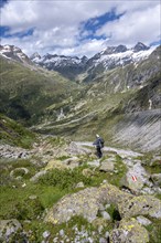 Mountaineers on a hiking trail in front of a picturesque mountain landscape, rocky mountain peaks