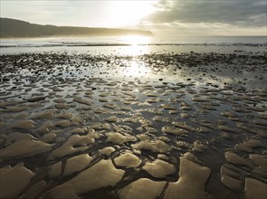 Sunrise at low tide at the shore of the Atlantic Ocean near Cape Trafalgar. Aerial view. Drone shot