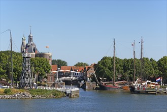 Town view of Enkhuizen with harbour entrance, lighthouse and historic old town with defence tower