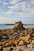 Striking orange-coloured rock formations in the evening light, on the coast of the English Channel