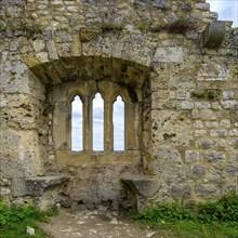 Gothic tracery window in an old fragment of wall, ruins of the medieval Hohenurach Castle, Bad