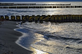 Sunset on the Baltic Sea beach, Ahrenshoop beach in the evening light with clouds, evening mood,