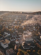 View over a town with autumn hills and fog in the air, Nagold, Black Forest, Germany, Europe