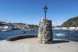 At the seaside in Risor, a traditional village with wooden white houses at the southern norwegian