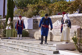 Group in traditional dress during a ceremony on a stage, visit of Federal President Frank-Walter