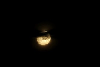 Full moon behind veil clouds, July, Germany, Europe