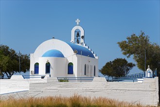 White-blue church with dome and bell tower under a clear blue sky, Church of Agia Marina, Paralia,