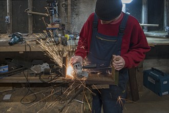 Young man at a Flex in his workshop, Mecklenburg-Vorpommern, Germany, Europe