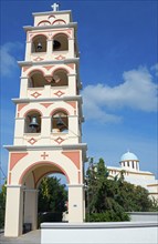 A tall Greek-style bell tower against a cloudless sky, Kounoupidiana, Chania, Crete, Greece, Europe