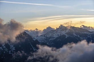 Mountain landscape at sunset, clouds around mountain peaks, Chamonix, Haute-Savoie, France, Europe