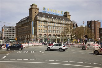 Main street with construction site and Hotel Handelshof with neon sign Essen, Die Folkwangstadt in