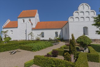 Typical Danish church with Renaissance gable in Hesselager, whitewashed, red tiled roof, curved