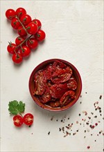 Dried tomatoes, in a bowl, top view, on a white background