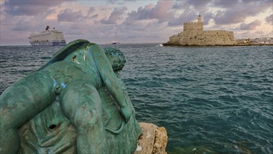 A damaged sculpture looks out over the sea and a fortress during a dramatic sunset, sky exchanged,