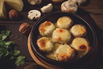 Traditional Georgian dish, appetizer, stuffed mushrooms, Sulguni cheese, baked in a Ketzi clay pan,