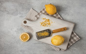 Grated lemon zest, on a cutting board, with a grater, top view, no people