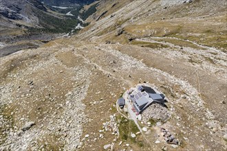 Aerial view of Cabane Arpitettaz in a rocky landscape close to a glacier, Zinal valley, Valais,