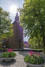 Svendborg Old Town, St. Nicolai Church, church tower, flower bowl, blooming tulips, tree, Fyn, Fyn