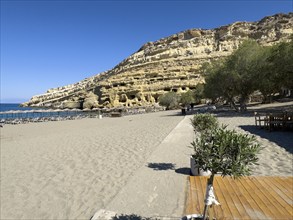 View of Matala beach, in the background sandstone rocks with former Roman necropolis with sandstone