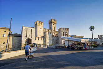 Market stall in front of Castello Scaligero, Sirmione, Lombardy, Italy, Europe