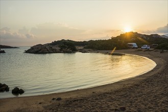 Lonely beach with granite rocks and campers, wild campsite, sunrise, Spiaggia Poltu Manzu, Capo