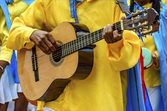 Guitarist playing his instrument during a popular religious festival in the state of Minas Gerais,