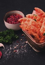 Fried mini pasties, with red sauce, top view, close-up, no people, selective focus