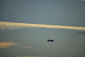 Aircraft in climb, after take-off at Düsseldorf International Airport, contrails from other