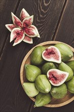 Fresh green figs, top view, on a wooden table