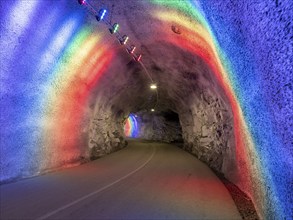 Colorful illuminated tunnel for bicycles and pedestrians leads up to Hardanger suspension bridge,