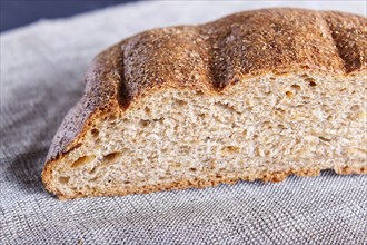 Cut buckwheat bread on linen napkin. close up