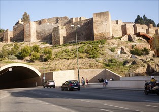 Traffic entering vehicle tunnel under historic Alcazaba fortress, Malaga, Spain, Europe