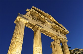 Gate of Athena Archegetis illuminated against the blue night sky, Roman Agora, Athens, Greece,