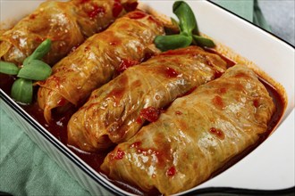 Stuffed cabbage rolls with minced meat, in tomato sauce, top view, without people, in the spotlight