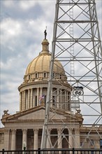 Oklahoma City, Oklahoma, A Phillips 66 oil derrick in front of the Oklahoma state capitol building