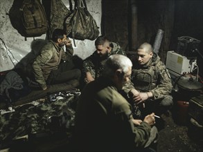 Iura, Volodymyr, Daniel and Ruslan wait with a 122 mm artillery gun from Soviet stocks for the