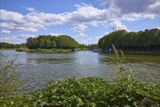 Dortmund-Ems canal under blue sky with cumulus clouds near Datteln, Ruhr area, Recklinghausen