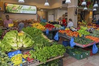 Lively vegetable market with a variety of fresh produce and people shopping, market hall, Xanthi,