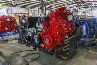 Cumins ISL diesel engines being installed onto chassis at Tiffin Motorhomes factory in Red Bay,