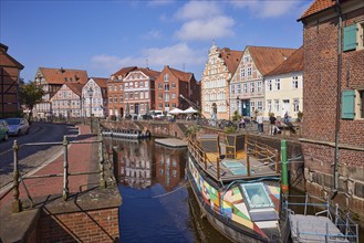 Harbour basin with railings, boats and the gabled houses, brick buildings and half-timbered houses