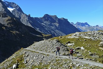 Two hikers on a narrow hiking trail in the hiking region of Kandersteg, Kandertal, Bernese