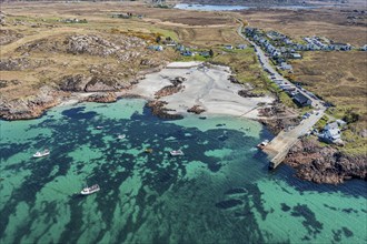 Aerial view, top down view on turquiose water at the beach of Fionnphort, boat traffic to Iona